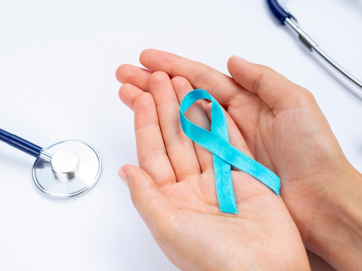 Hands holding a cancer awareness ribbon